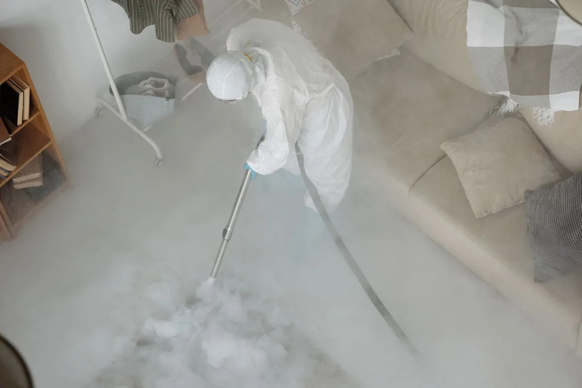 Biohazard cleanup technician in protective equipment, Lake Winnebago, MO